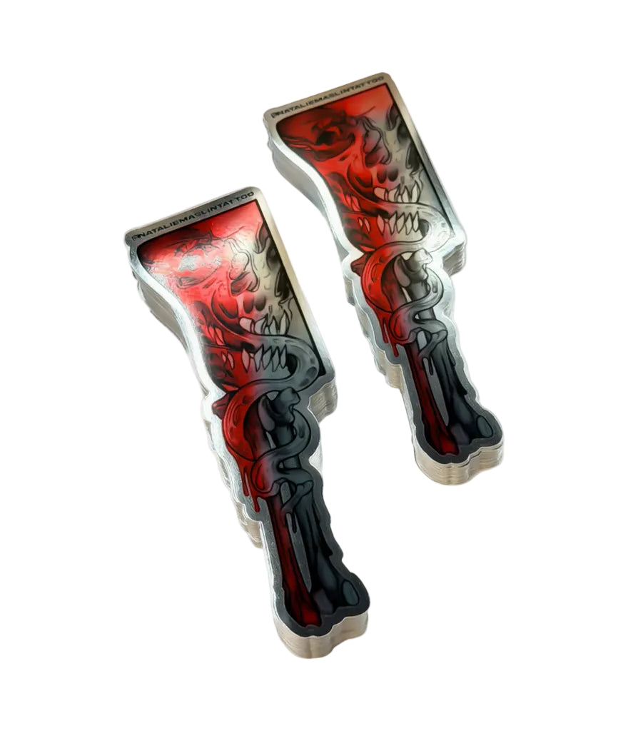 Two metallic objects with red and black designs on a white background